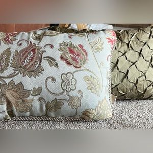 2 Accent Pillows. Solid green & floral design pillow with flap on other side.